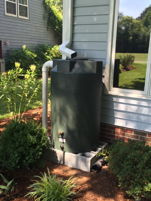 Dark Green 125 gallon rainwater harvesting tank installation